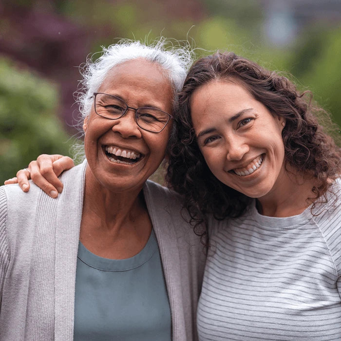 Two women smiling while posing.